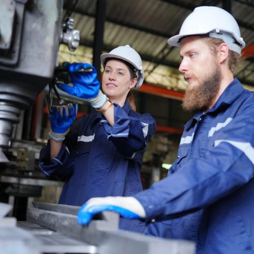 Industrial Engineer at work in factory, industrial engineers working at automated AI robotic production factory - New technology concept
